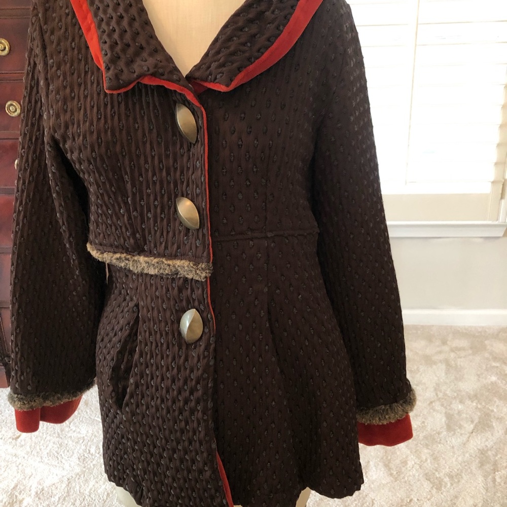 Brown jacket. Trimmed in orange